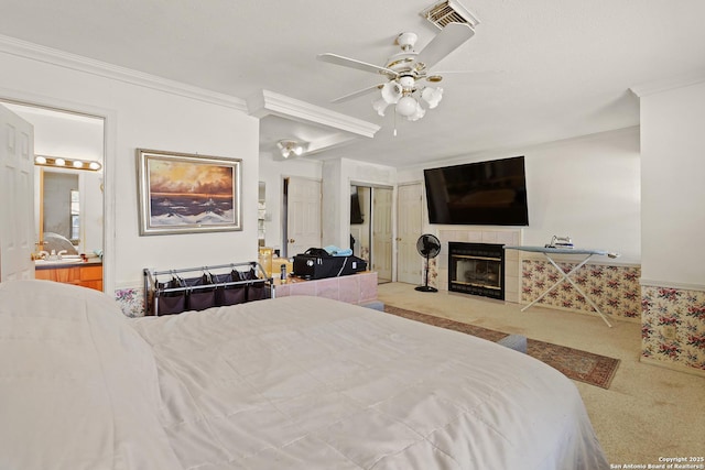 bedroom featuring light colored carpet, ornamental molding, and a fireplace