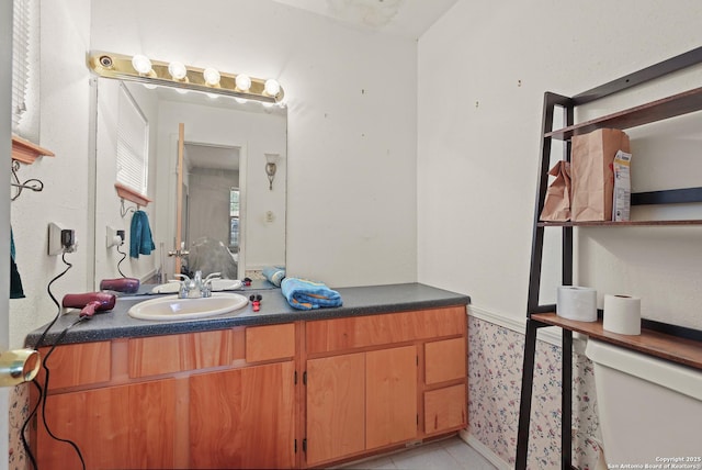 bathroom with vanity and toilet