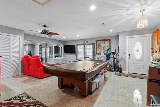 rec room featuring ceiling fan, billiards, a textured ceiling, and ornate columns