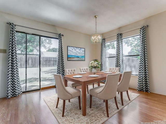 dining room with a chandelier and light wood-type flooring