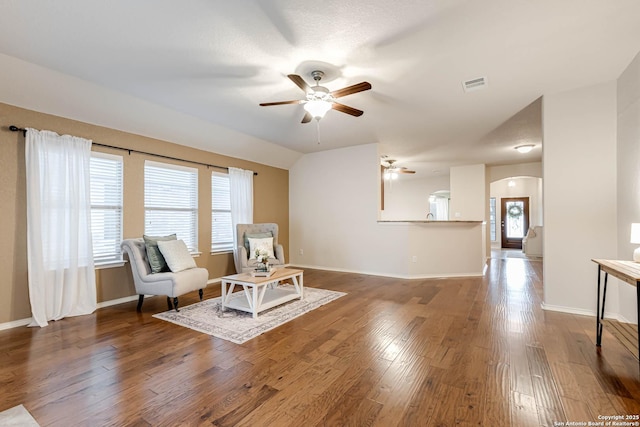 living area with vaulted ceiling, ceiling fan, and hardwood / wood-style floors