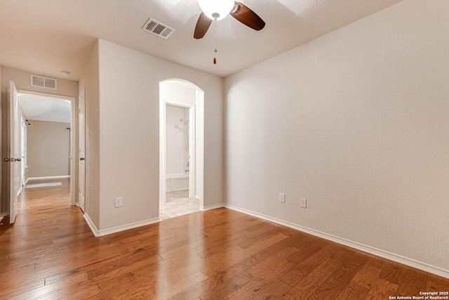 unfurnished room featuring ceiling fan and hardwood / wood-style floors