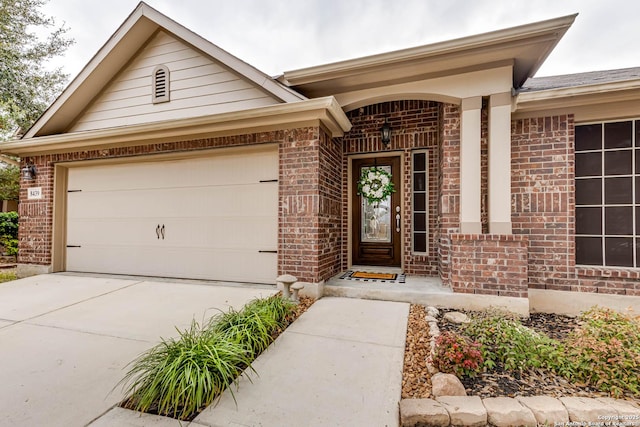 doorway to property with a garage