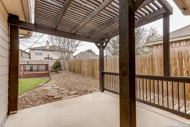 view of patio / terrace featuring a wooden deck and a pergola