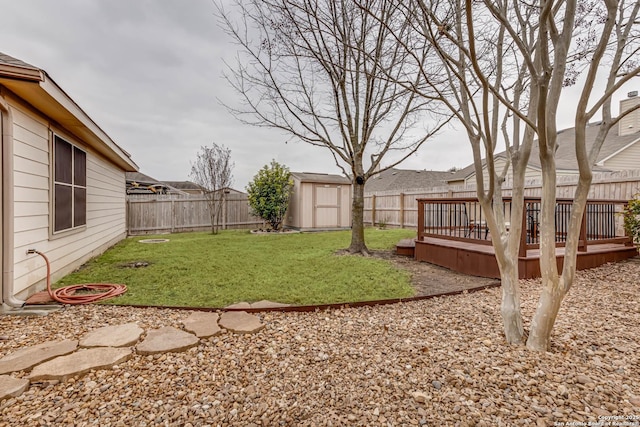 view of yard featuring a wooden deck and a storage unit