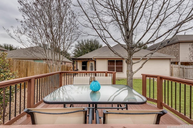 wooden deck featuring a yard