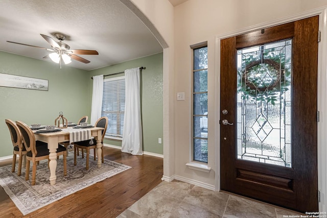 entryway featuring a textured ceiling, ceiling fan, and light hardwood / wood-style flooring