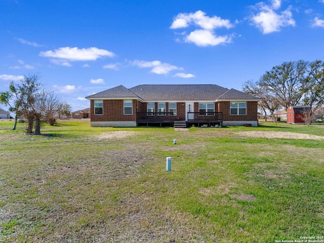 ranch-style house featuring a wooden deck and a front lawn