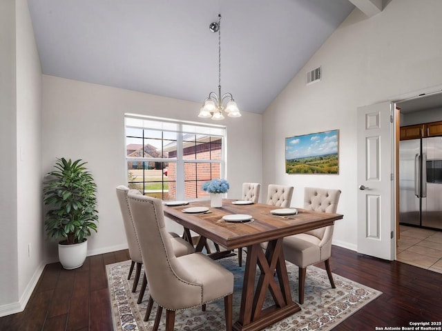 dining area featuring high vaulted ceiling, an inviting chandelier, and dark hardwood / wood-style flooring