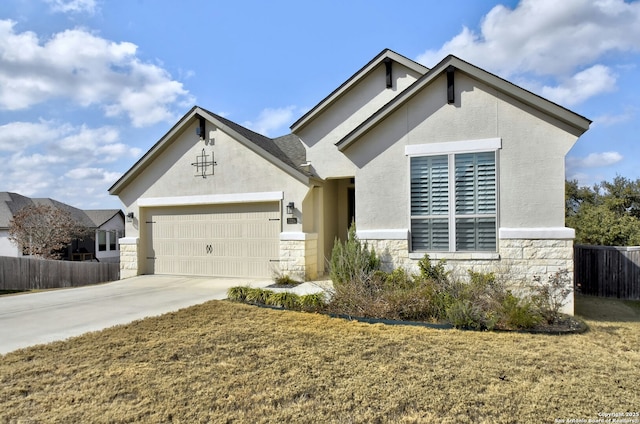 view of front facade with a garage and a front yard