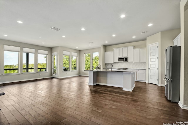 kitchen featuring white cabinetry, appliances with stainless steel finishes, dark hardwood / wood-style floors, and a kitchen island with sink