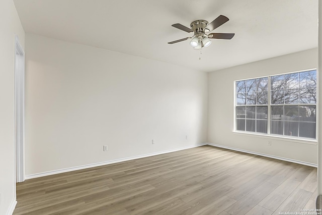 spare room featuring hardwood / wood-style floors and ceiling fan