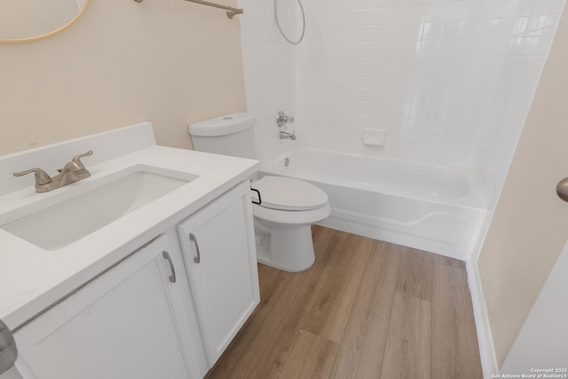 full bathroom with vanity, toilet,  shower combination, and hardwood / wood-style floors