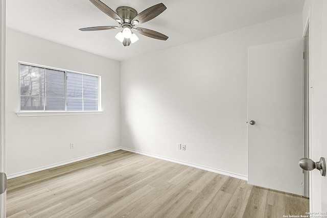 spare room with ceiling fan and light wood-type flooring