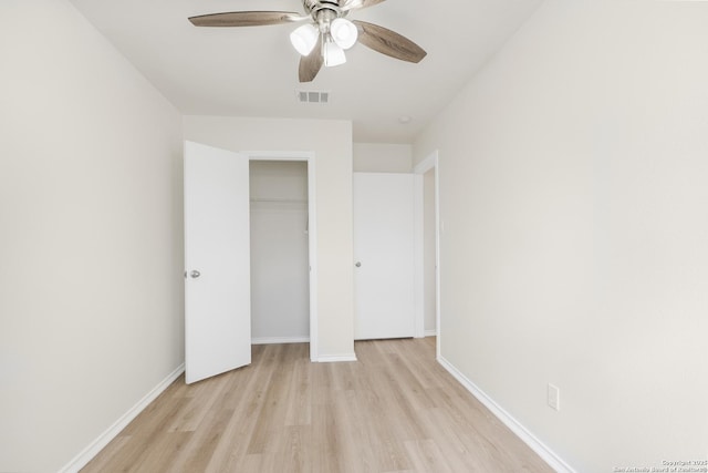 unfurnished bedroom with ceiling fan, light hardwood / wood-style floors, and a closet