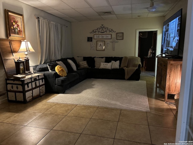 tiled living room featuring a paneled ceiling