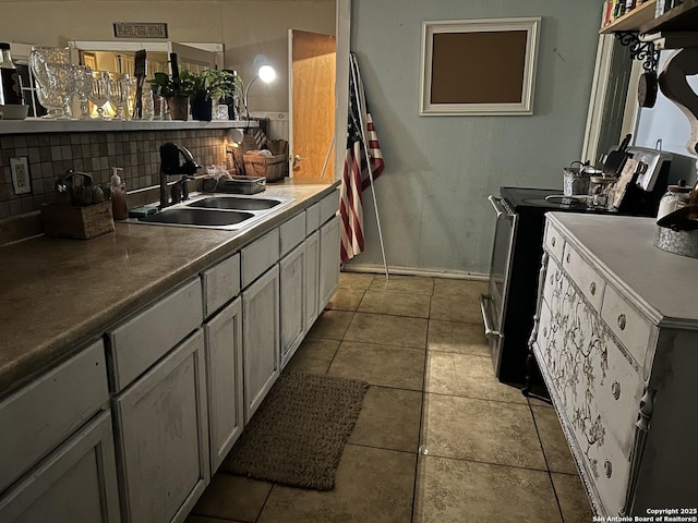 kitchen featuring sink, light tile patterned floors, backsplash, and electric stove