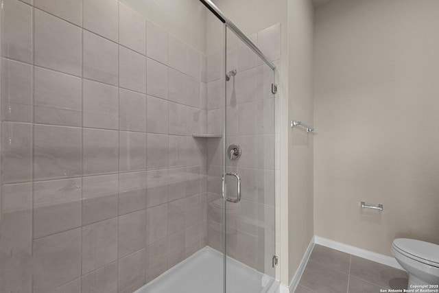4237 Carlotta Dr, New Braunfels, TX 78130 - bathroom with baseboards, a shower stall, toilet, and tile patterned flooring