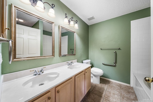 full bathroom featuring vanity, tile patterned floors, a textured ceiling, and toilet