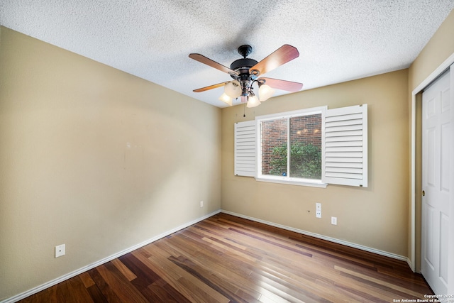 unfurnished bedroom featuring ceiling fan, wood-type flooring, a closet, and a textured ceiling