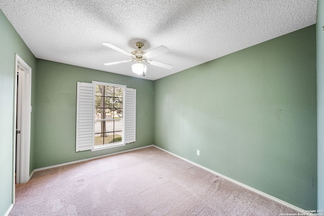 carpeted empty room featuring a textured ceiling and ceiling fan