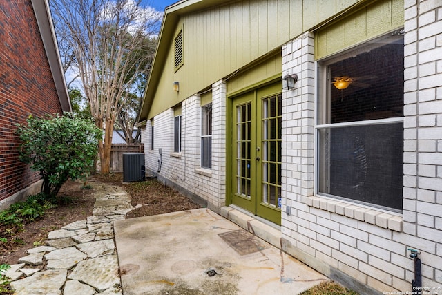 view of property exterior with a patio, central AC, and french doors