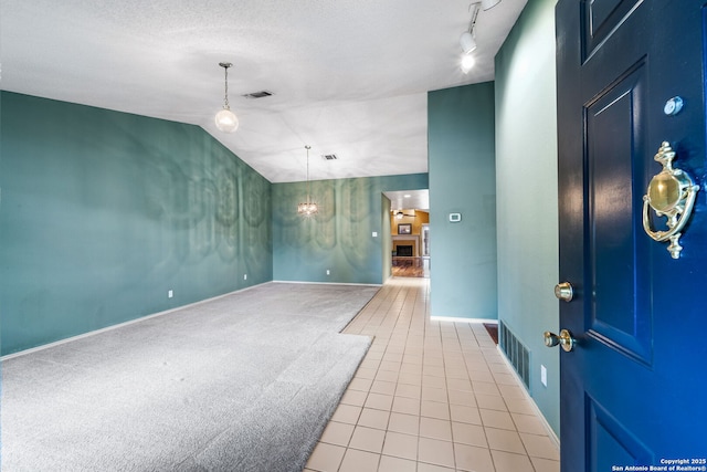 interior space featuring track lighting and a textured ceiling