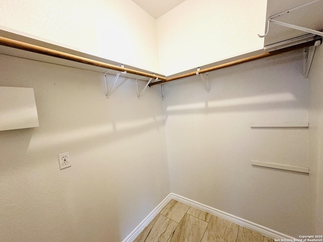 walk in closet with hardwood / wood-style floors