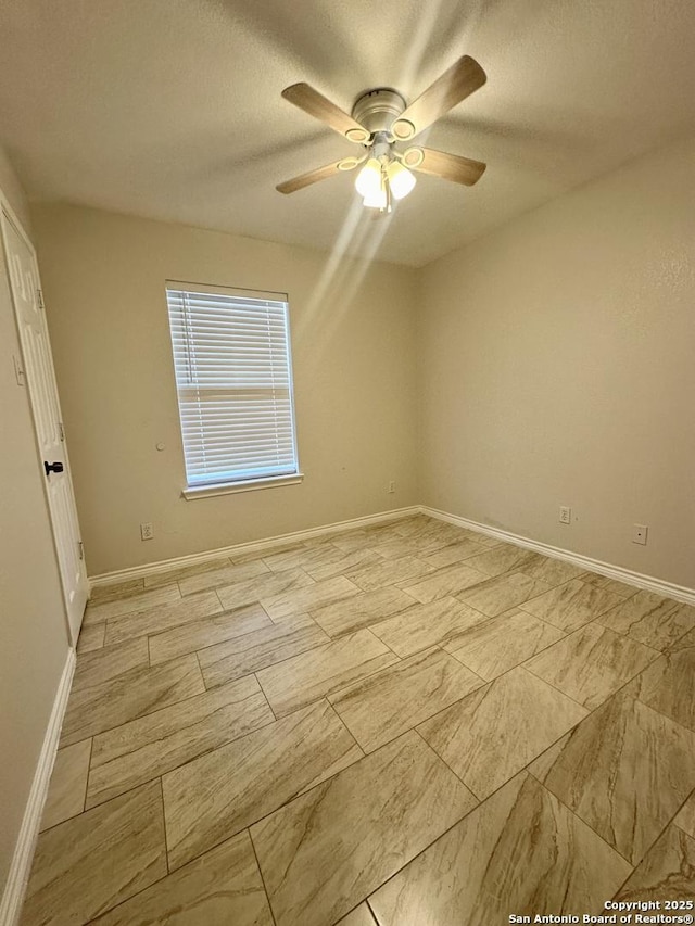 empty room featuring ceiling fan and a textured ceiling