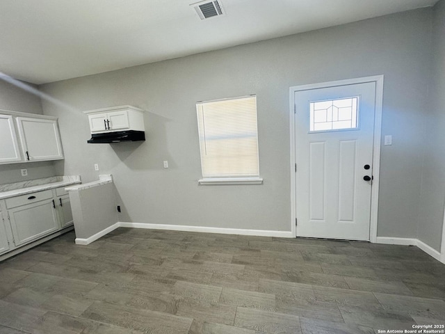 laundry area with light wood-type flooring