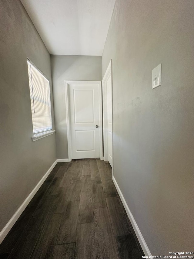 hallway with dark hardwood / wood-style flooring