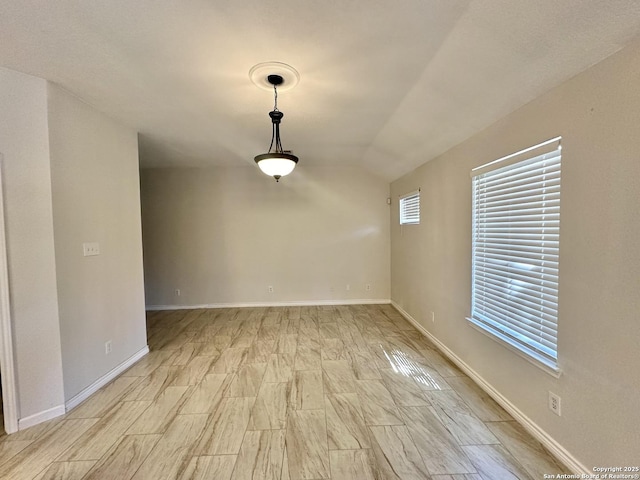 spare room with vaulted ceiling