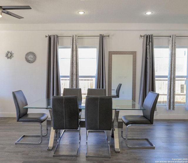 dining area featuring a healthy amount of sunlight, dark wood-type flooring, and ceiling fan