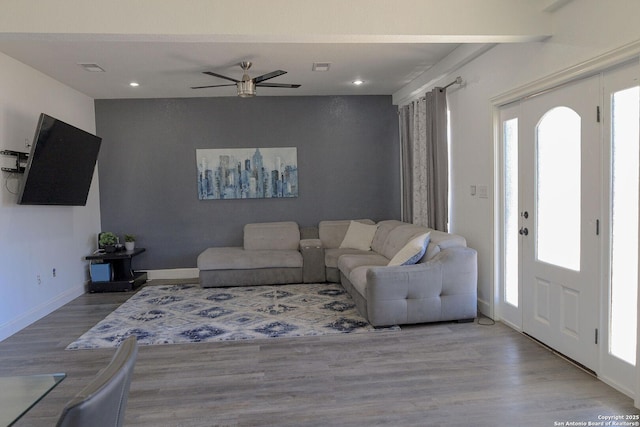 living room with ceiling fan and light hardwood / wood-style flooring