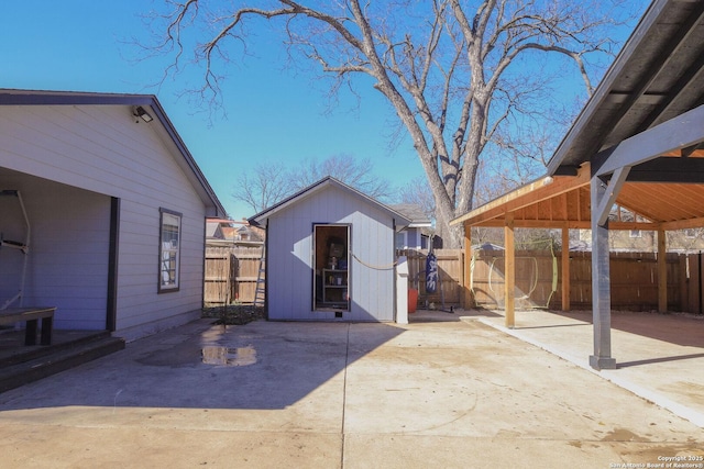 rear view of property with a gazebo, a storage unit, and a patio