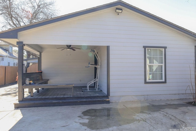 rear view of property featuring ceiling fan