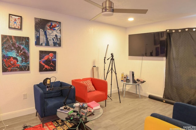 sitting room featuring ceiling fan and light wood-type flooring