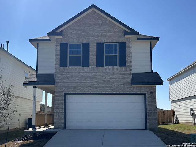 view of front property featuring central AC unit and a garage