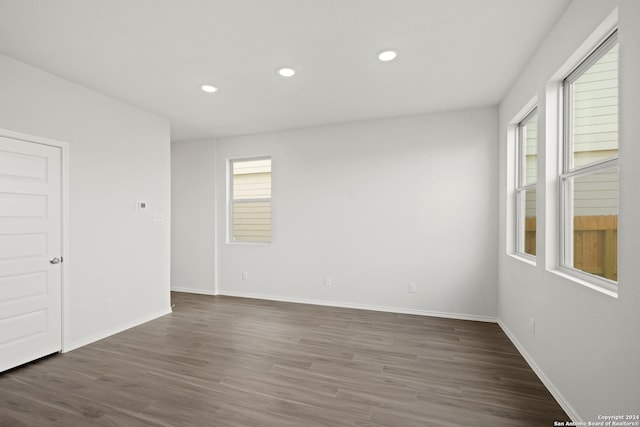 unfurnished room with dark wood-type flooring