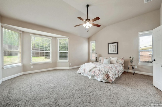 carpeted bedroom featuring multiple windows, vaulted ceiling, and ceiling fan