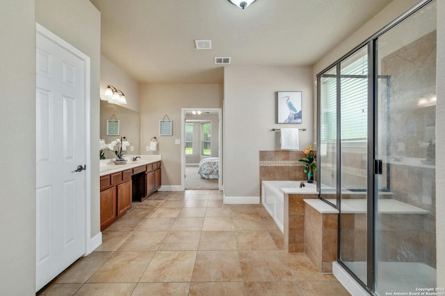 bathroom with vanity, plenty of natural light, tile patterned floors, and plus walk in shower