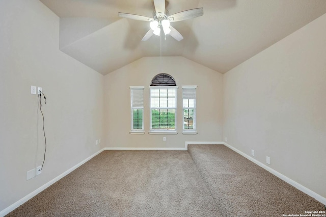 carpeted spare room with vaulted ceiling and ceiling fan