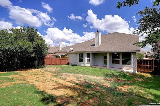 back of house with a yard