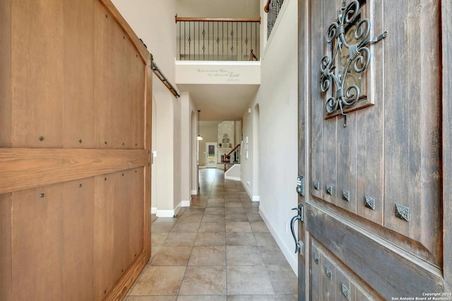 tiled foyer entrance featuring a high ceiling