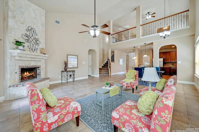 living room with light tile patterned floors, a fireplace, and ceiling fan