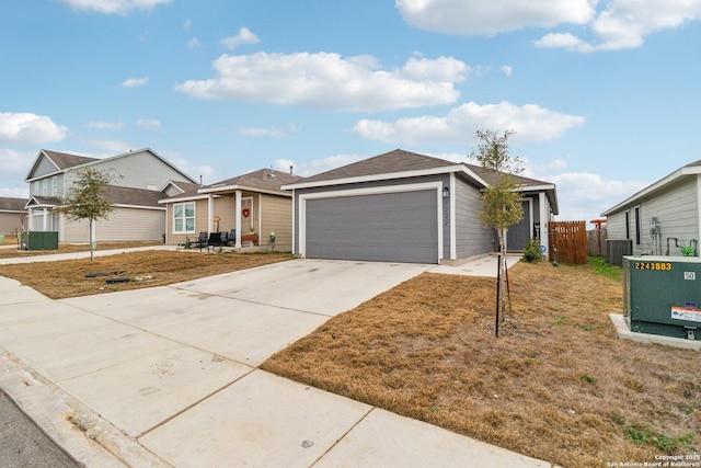 ranch-style home with a garage and central air condition unit