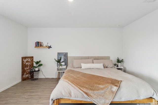 bedroom with hardwood / wood-style flooring