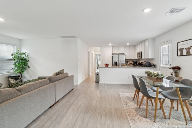 dining space featuring light hardwood / wood-style floors