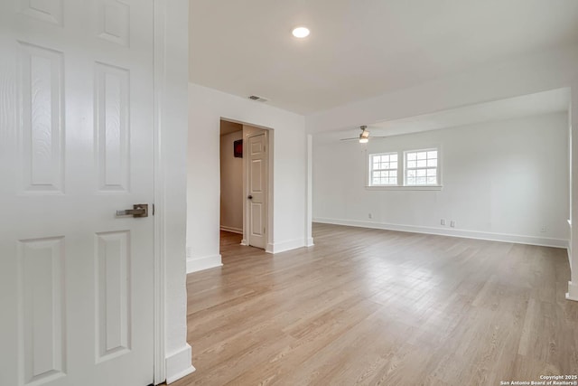 unfurnished room with ceiling fan and light hardwood / wood-style flooring