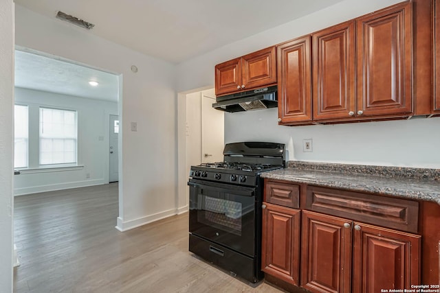 kitchen featuring black gas range and light hardwood / wood-style floors